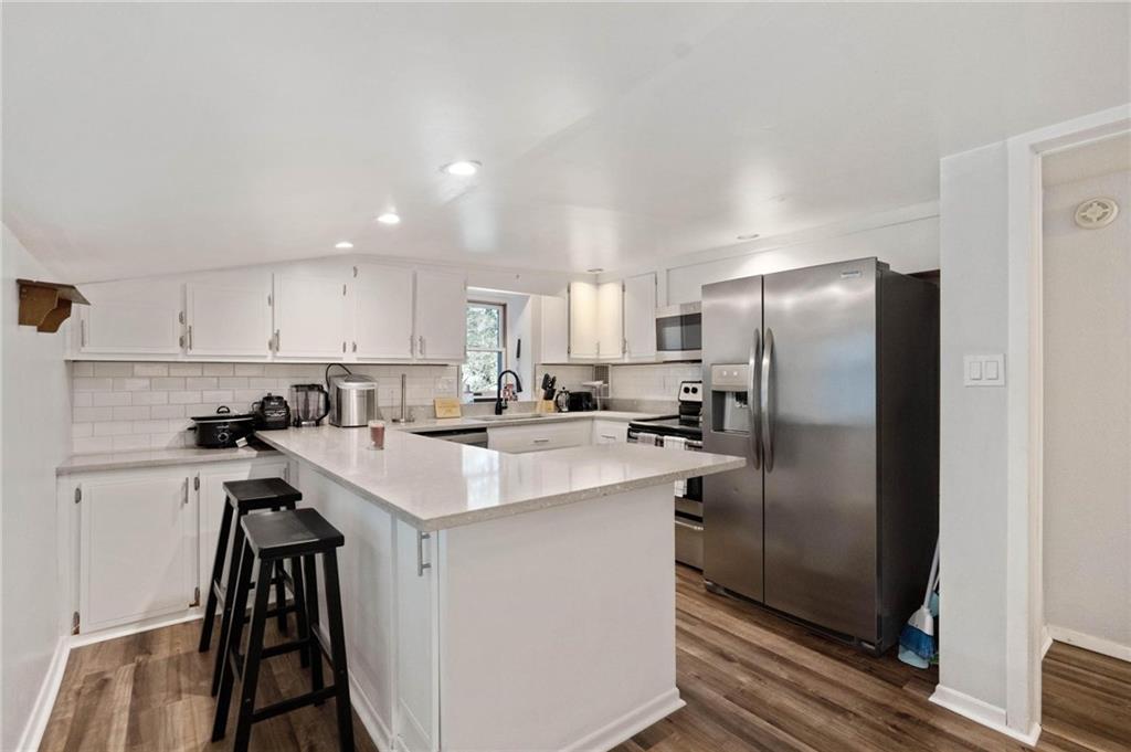 134 Wilson Avenue Cecil, PA 15321 - Photo 17 of 25 a kitchen with a sink a refrigerator a stove and cabinets