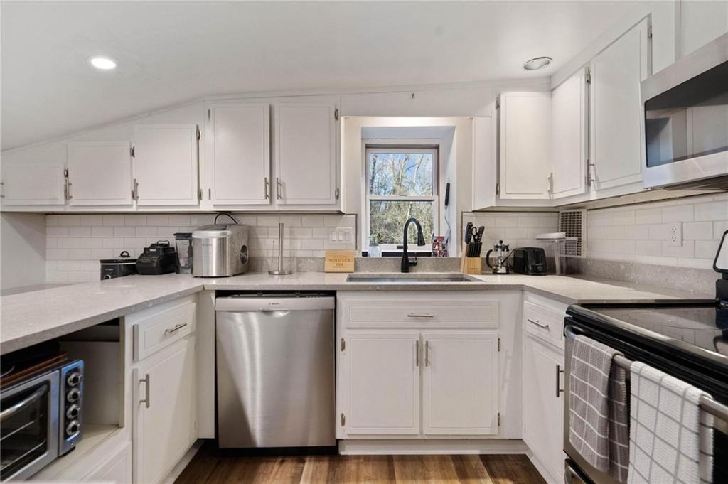 134 Wilson Avenue Cecil, PA 15321 - Photo 18 of 25 a kitchen with white cabinets and white appliances