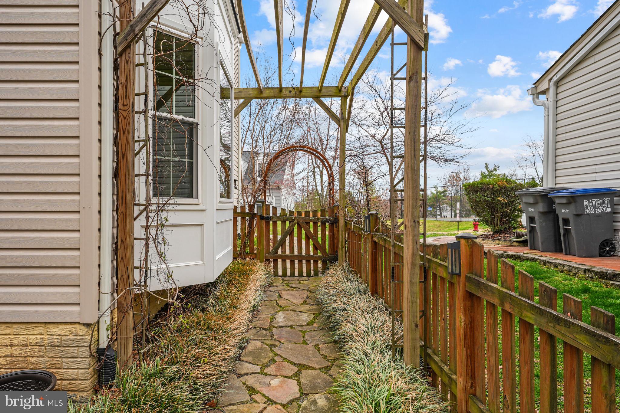 42943 Gotham Way Ashburn, VA 20147 - Photo 44 of 53 Charming pathway on side of house
