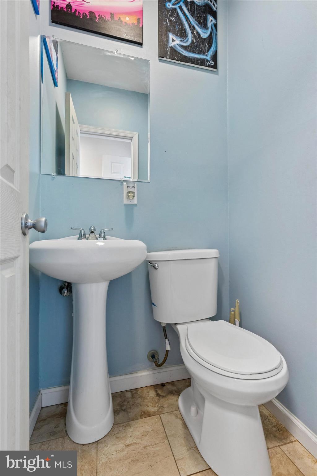 1126 Plowshare Road Blue Bell, PA 19422 - Photo 12 of 30 a bathroom with a toilet sink and mirror