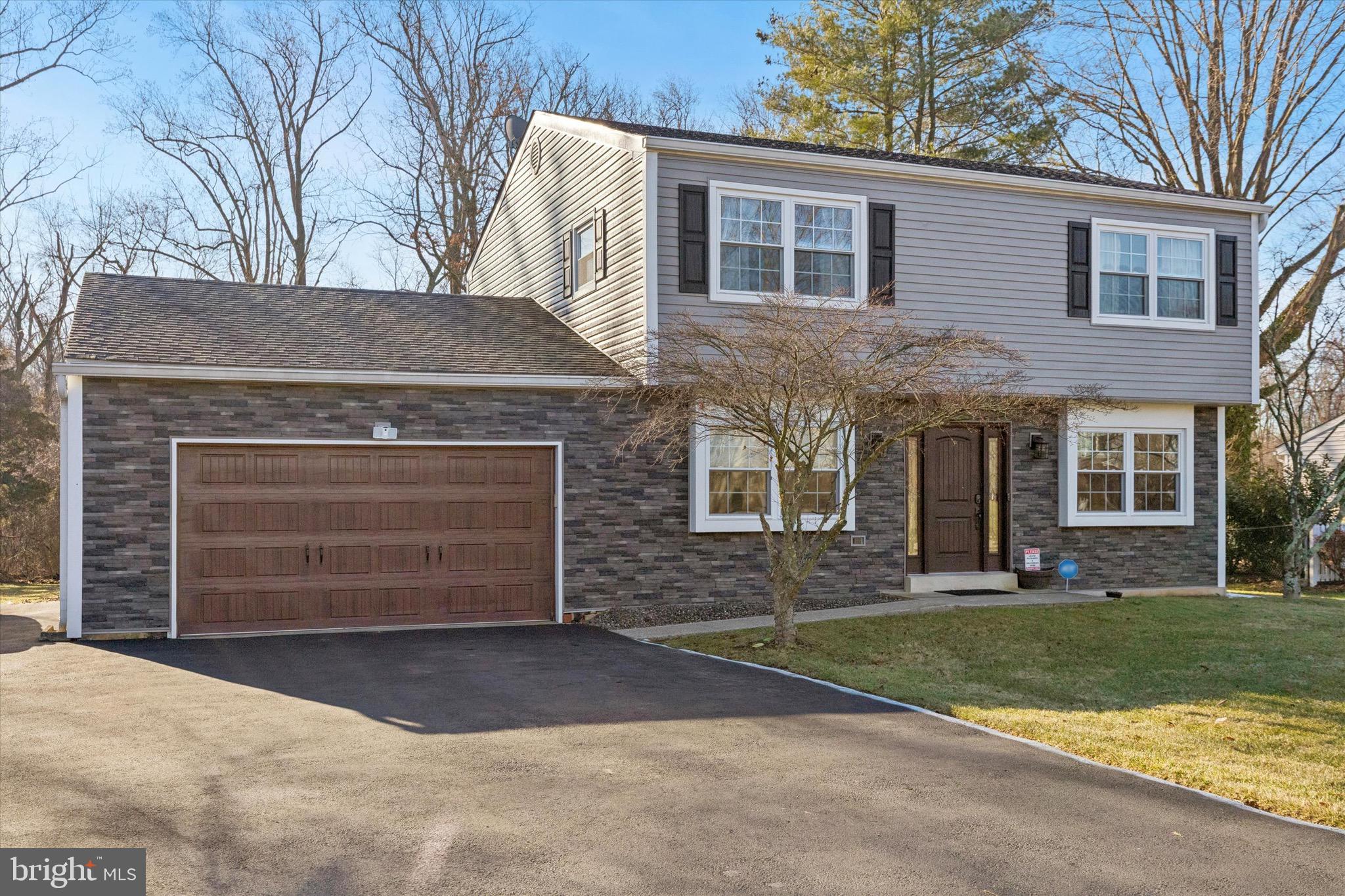 1126 Plowshare Road Blue Bell, PA 19422 - Photo 26 of 30 a front view of a house with a yard and garage