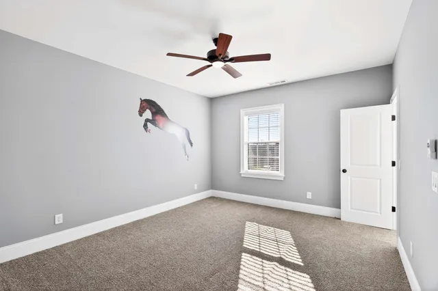 a view of room with window and ceiling fan