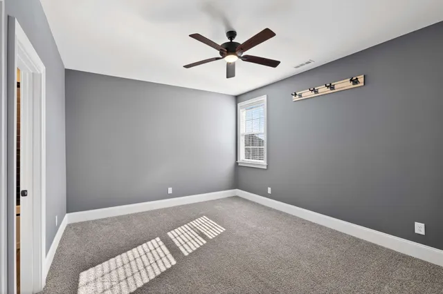 a bathroom with a granite countertop sink a toilet and shower