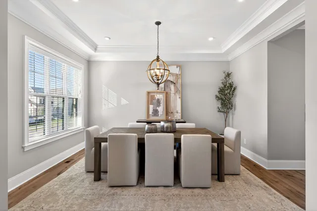 a view of a dining room with furniture window and wooden floor