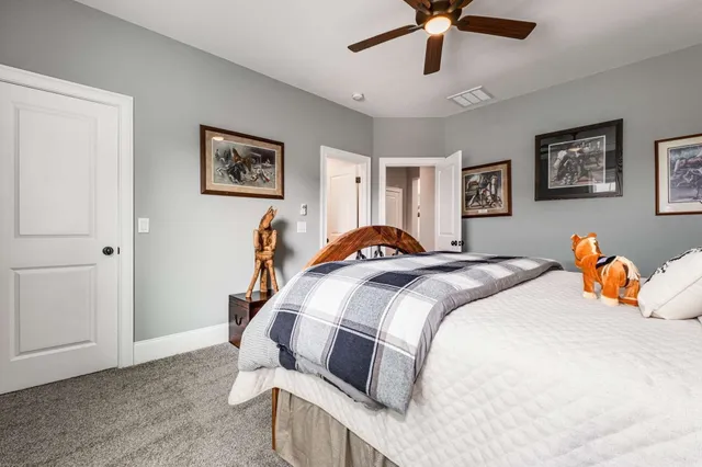 an aerial view of a house with swimming pool and trees