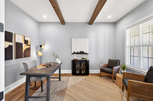 a living room with furniture and a potted plant