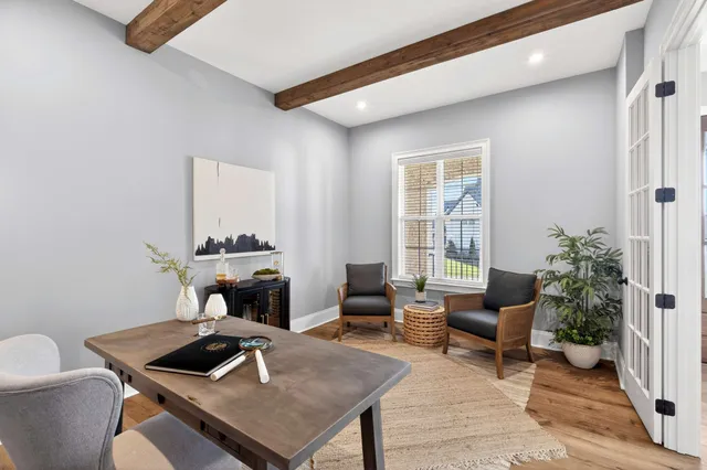 a living room with couches a dining table and chairs with wooden floor