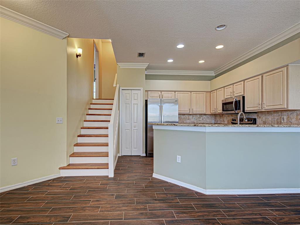 1801 Highland Road Osprey, FL 34229 - Photo 17 of 40 a room with stainless steel appliances a refrigerator and cabinets