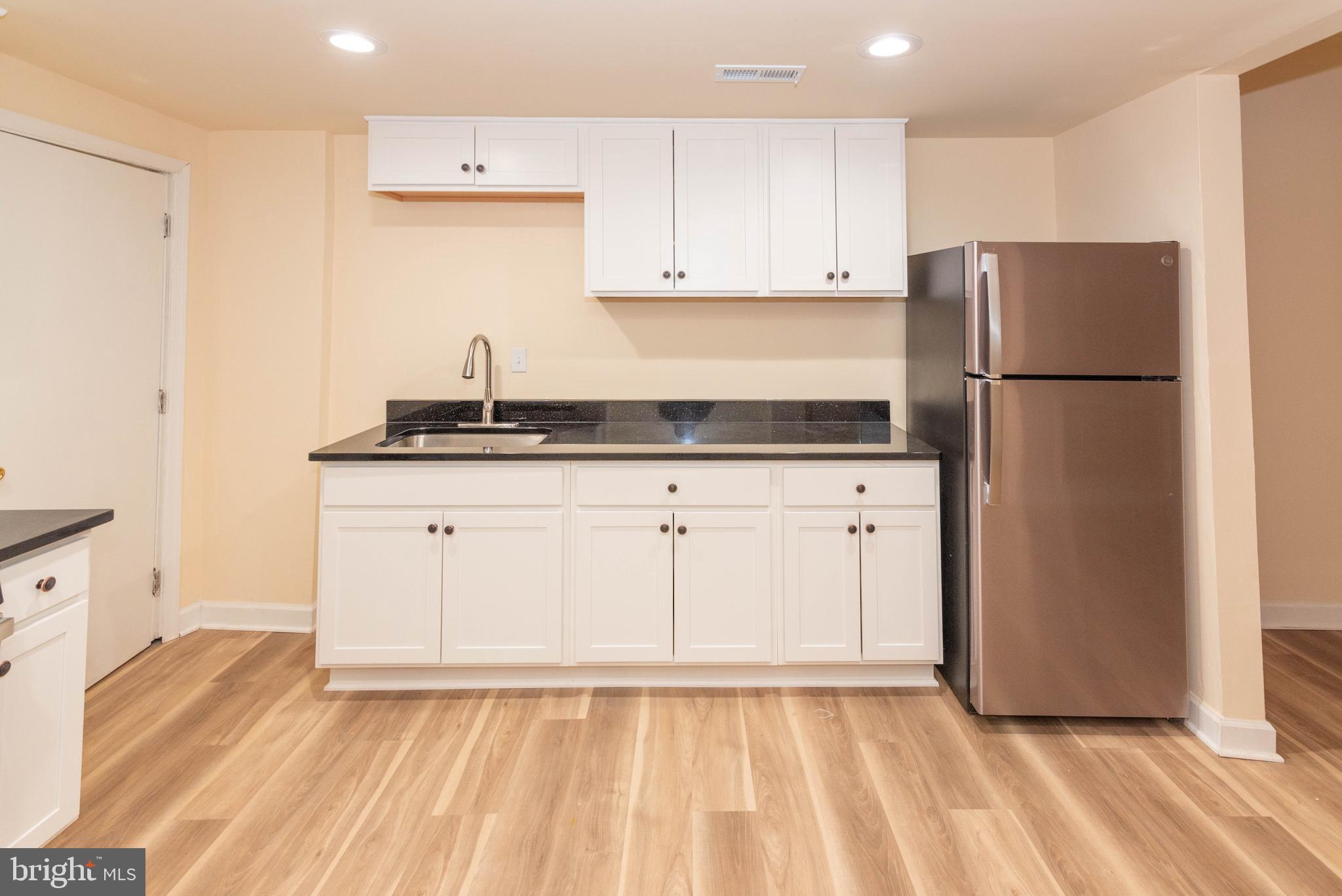 2000 Hollins Ferry Road Baltimore, MD 21230 - Photo 11 of 43 a kitchen with granite countertop white cabinets and refrigerator
