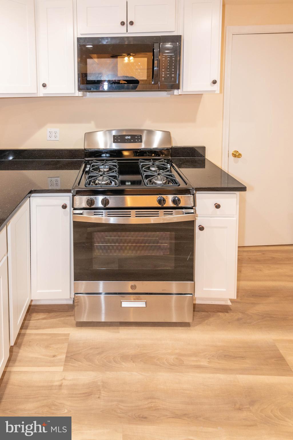 2000 Hollins Ferry Road Baltimore, MD 21230 - Photo 13 of 43 a kitchen with stainless steel appliances granite countertop a stove and a microwave