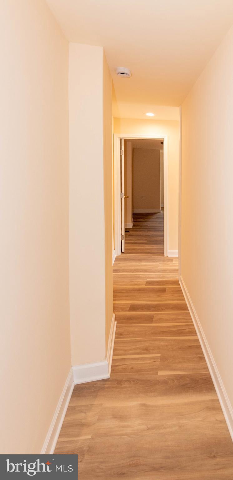 2000 Hollins Ferry Road Baltimore, MD 21230 - Photo 25 of 43 a view of a hallway with wooden floor and a bathroom