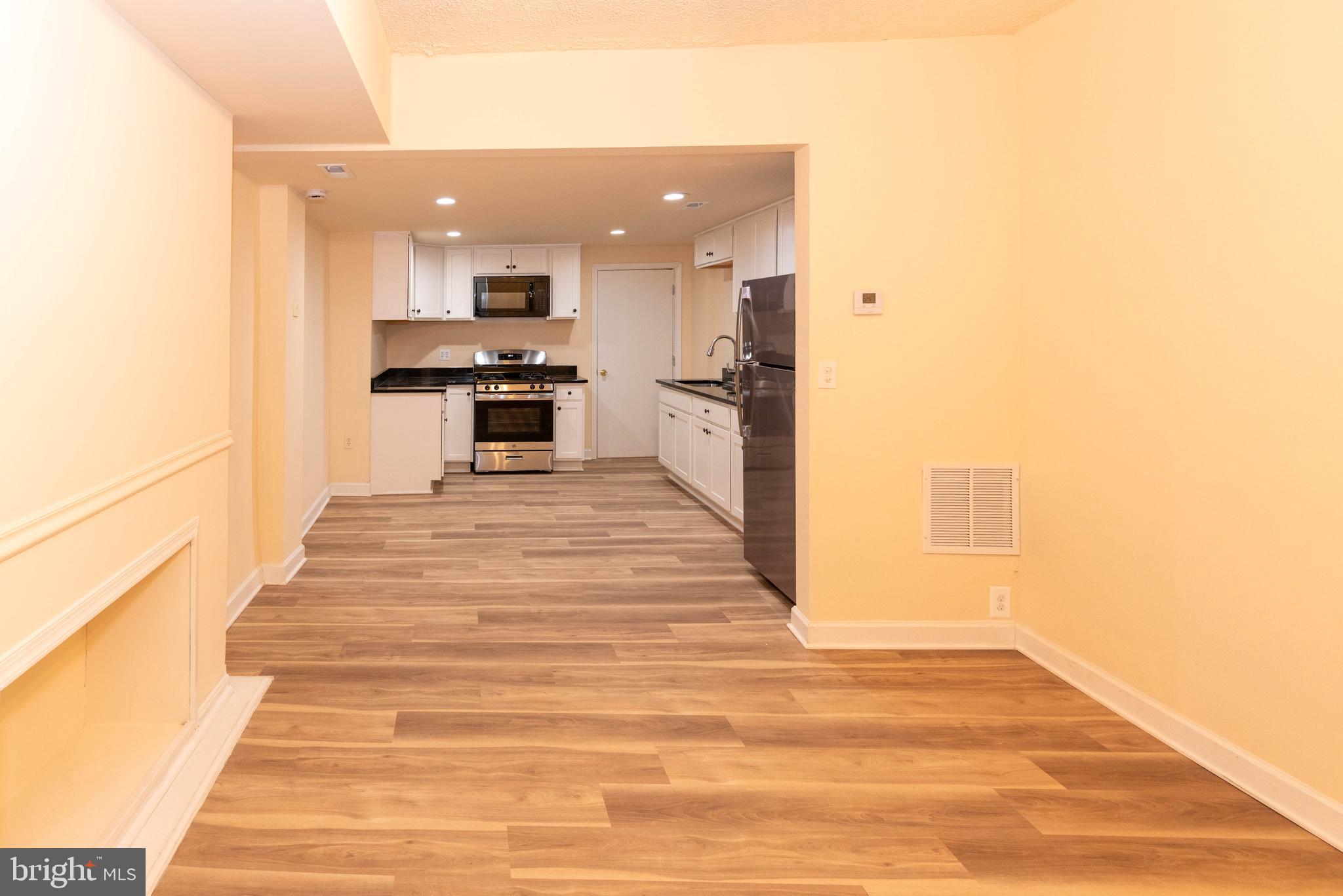 2000 Hollins Ferry Road Baltimore, MD 21230 - Photo 9 of 43 a kitchen with stainless steel appliances kitchen island granite countertop a refrigerator and a stove top oven