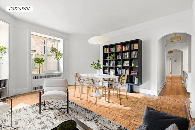 a living room with furniture a rug and a window