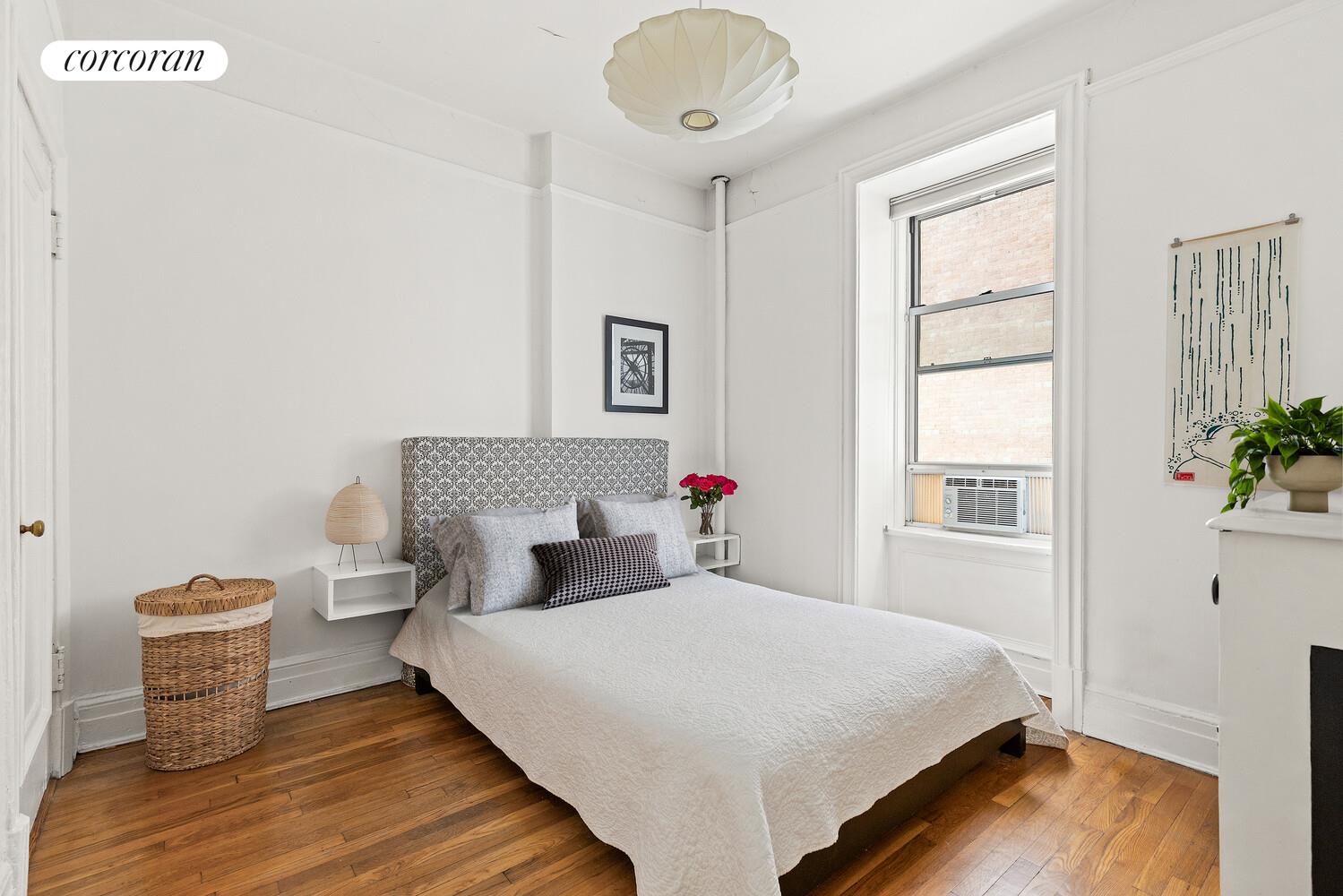 301 West 108th Street, Unit 2B Manhattan, NY 10025 - Photo 3 of 6 a bedroom with a bed and wooden floor