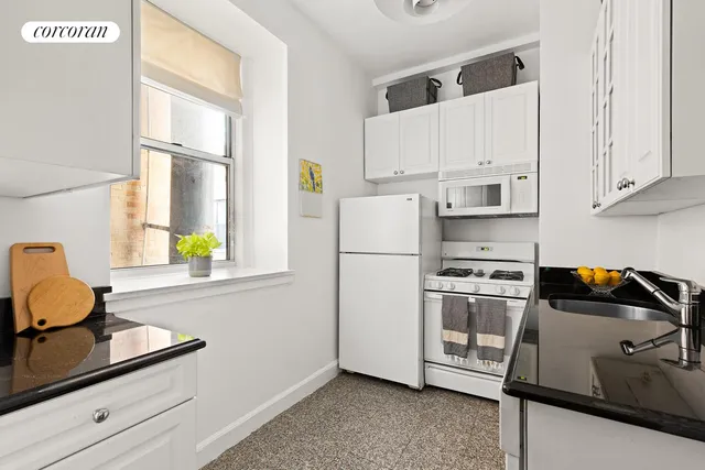 a kitchen with stainless steel appliances a stove a refrigerator and a sink