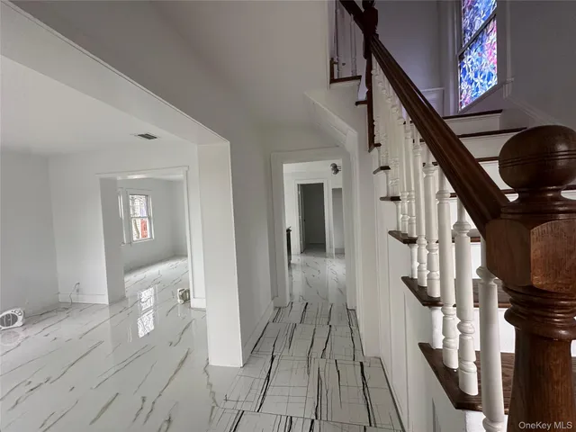 a view of an entryway with wooden floor and staircase