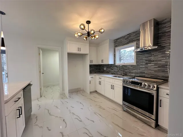 a kitchen with granite countertop a stove a sink and dishwasher