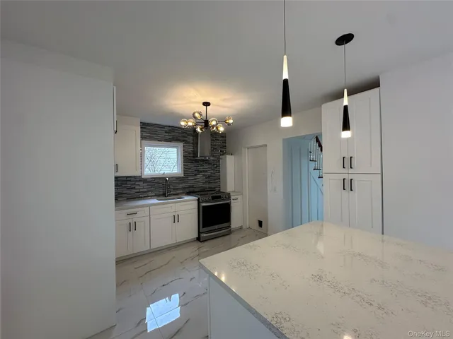 a kitchen with a sink a refrigerator and a stove