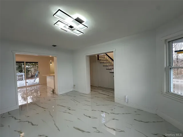 an empty room with windows and entrance