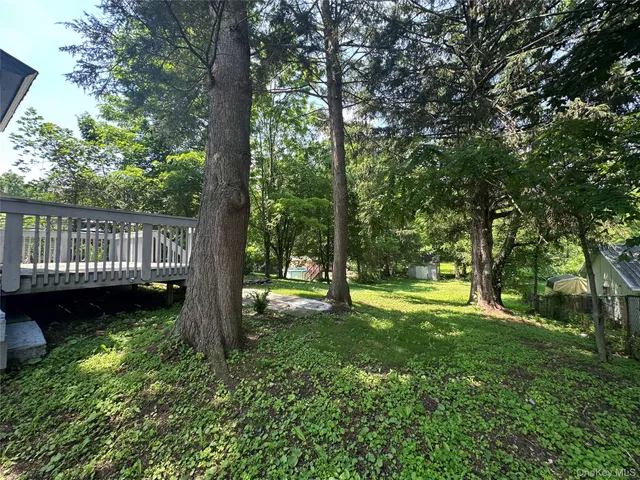 a view of a yard with a trees in the background
