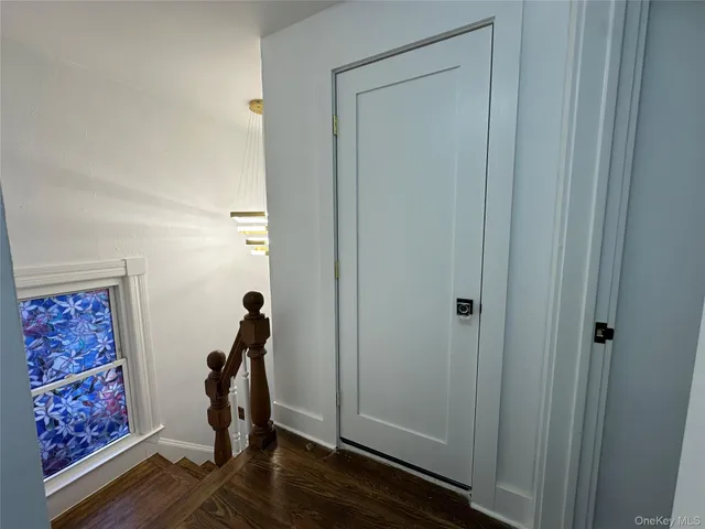 a view of room with hardwood floor and closet