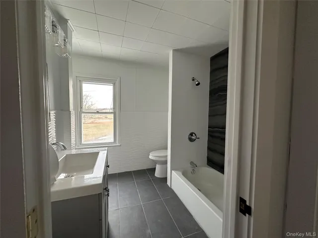a bathroom with a bathtub toilet and sink