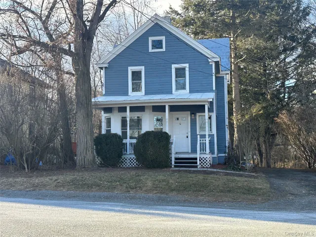 a view of a house with a deck and a yard