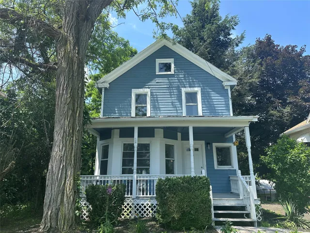 a front view of a house with garden
