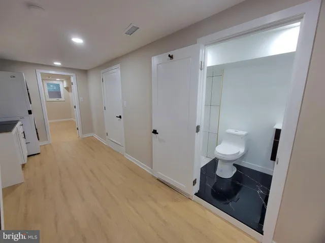 a view of empty room with wooden floor