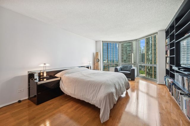 a bedroom with a bed and a book shelf