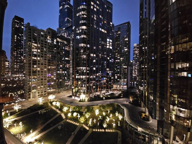 a view of a balcony with furniture and a potted plant on a dresser