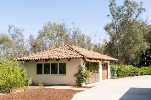 a front view of a house with a garden