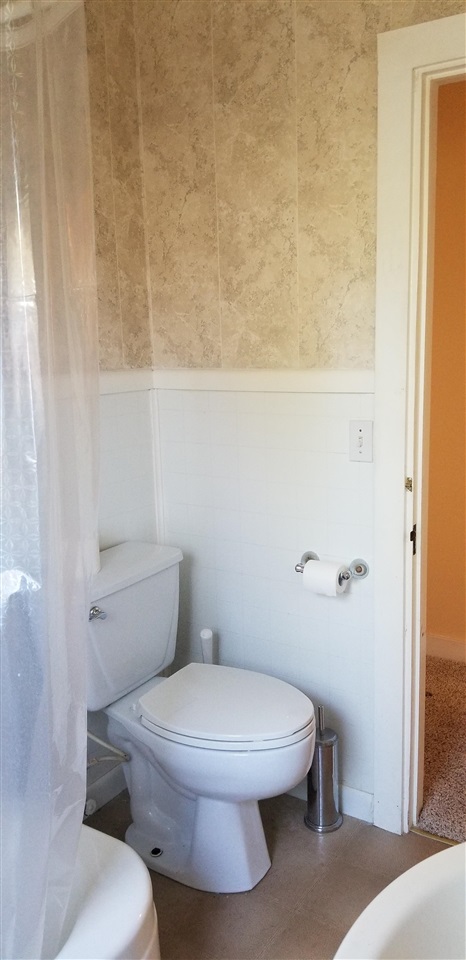 381 Aleut Street Biggs, CA 95917 - Photo 31 of 35 a white toilet sitting next to a shower curtain