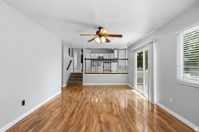 142 East 2675th Street South Clearfield, UT 84015 - Photo 16 of 49 Spacious interior featuring wood-finish flooring, a ceiling fan, and light gray wall tones