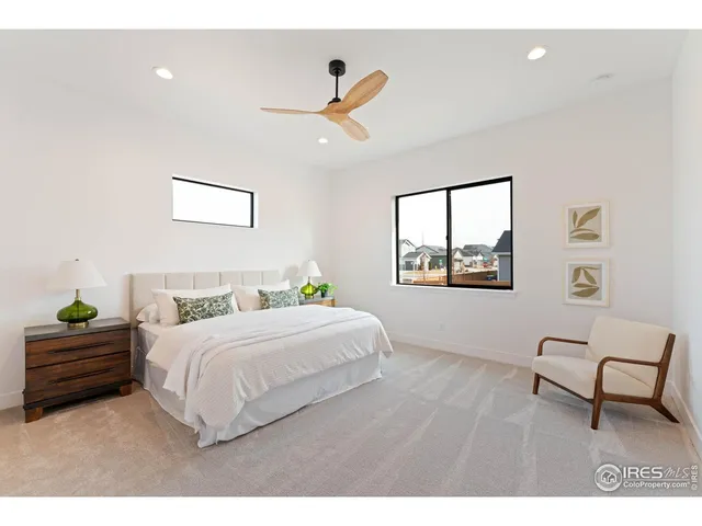 a bedroom with a bed and a painting on the wall