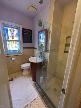 a bathroom with a shower and a sink