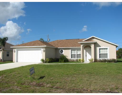 4286 Southwest Whitebread Road Port St. Lucie, FL 34953 - Photo 1 of 6 a front view of house with yard and green space