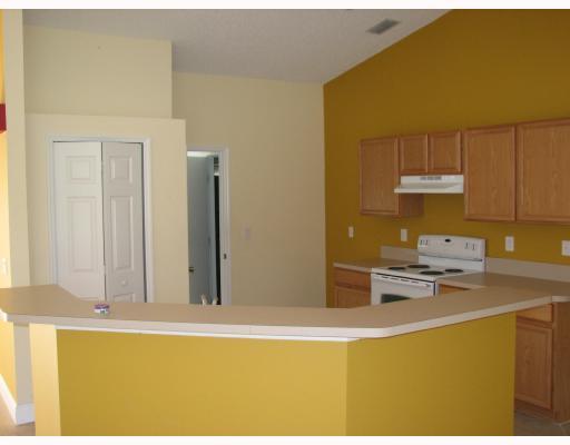 4286 Southwest Whitebread Road Port St. Lucie, FL 34953 - Photo 2 of 6 a kitchen with stainless steel appliances granite countertop a sink and cabinets