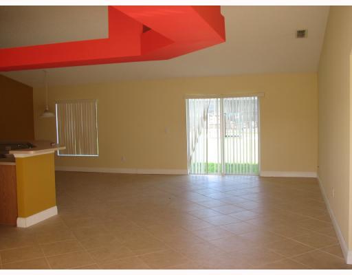 4286 Southwest Whitebread Road Port St. Lucie, FL 34953 - Photo 3 of 6 a view of an empty room with wooden floor and a window