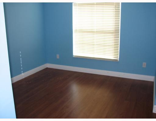 4286 Southwest Whitebread Road Port St. Lucie, FL 34953 - Photo 5 of 6 an empty room with wooden floor and windows