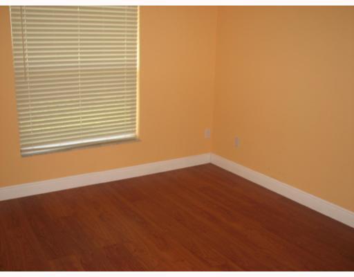 4286 Southwest Whitebread Road Port St. Lucie, FL 34953 - Photo 6 of 6 a view of an empty room with wooden floor and a window