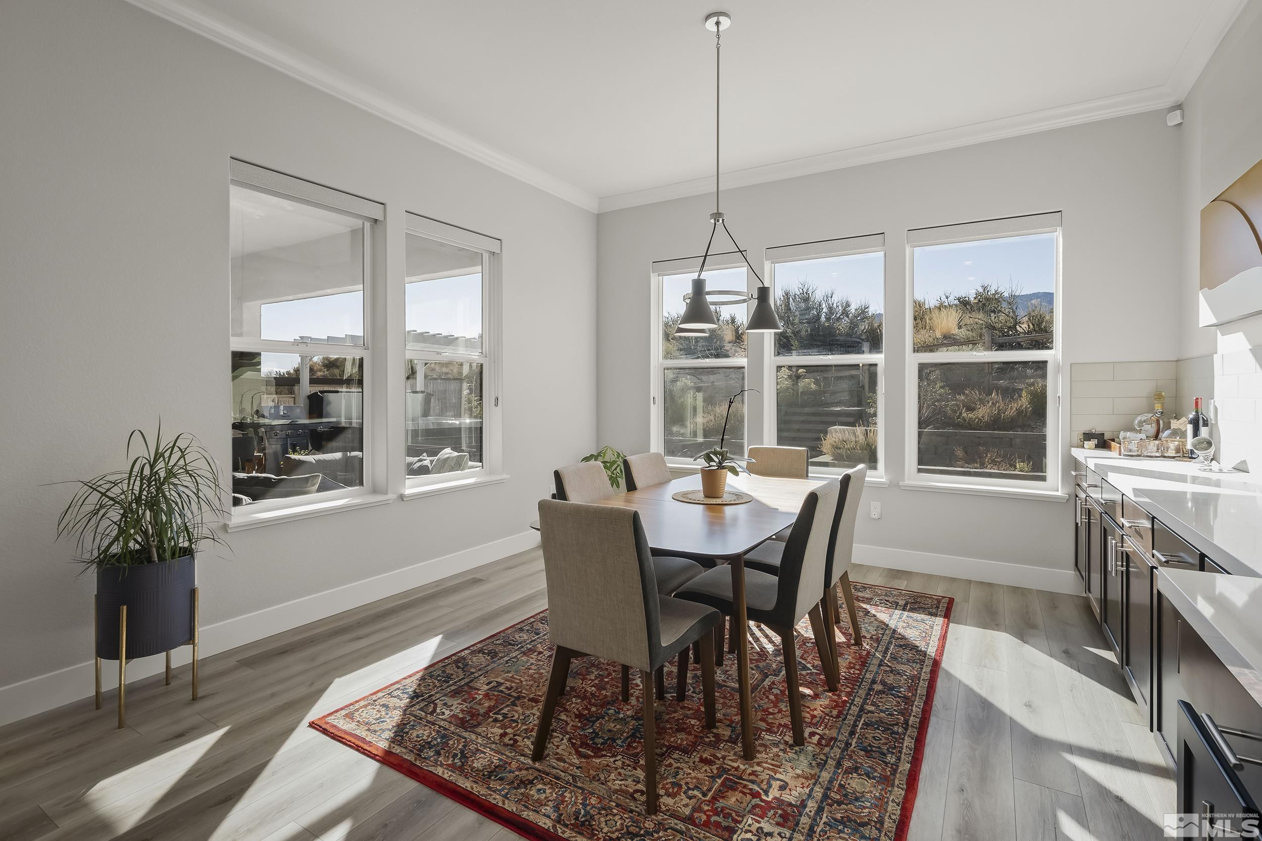 8780 Larkhaven Trail Reno, NV 89523 - Photo 13 of 28 a view of a dining room with furniture wooden floor and chandelier