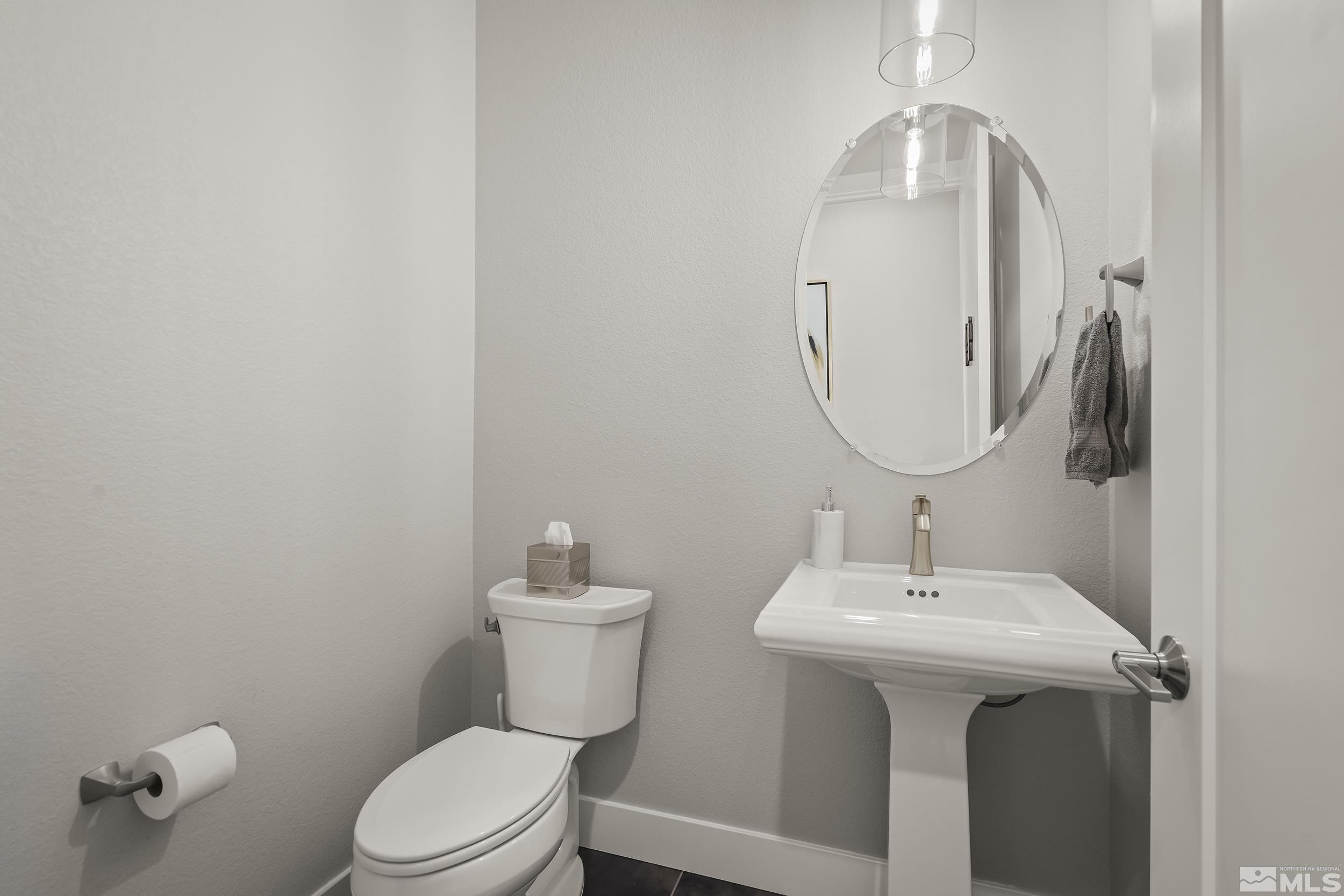 8780 Larkhaven Trail Reno, NV 89523 - Photo 20 of 28 a bathroom with a sink a mirror and toilet