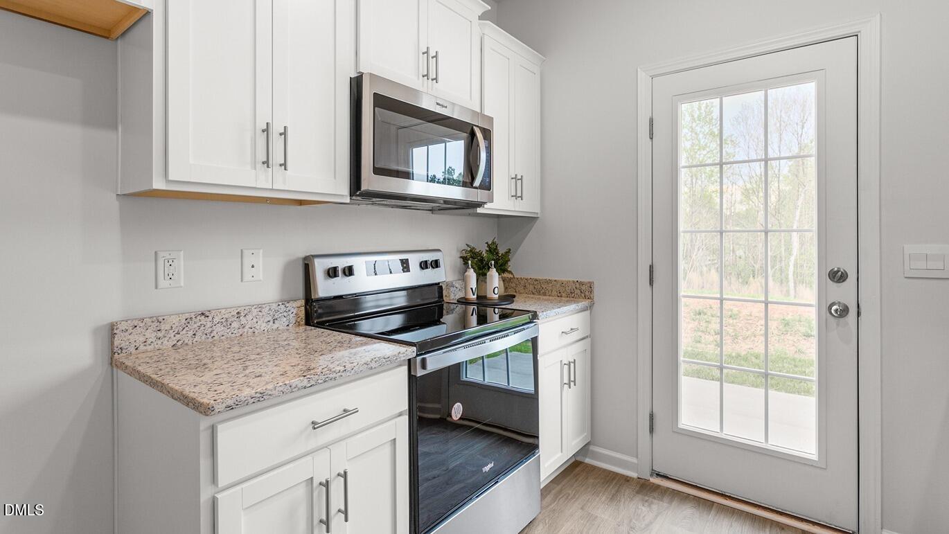 186 Canopy Drive Graham, NC 27253 - Photo 10 of 23 a kitchen with granite countertop cabinets stainless steel appliances and a sink