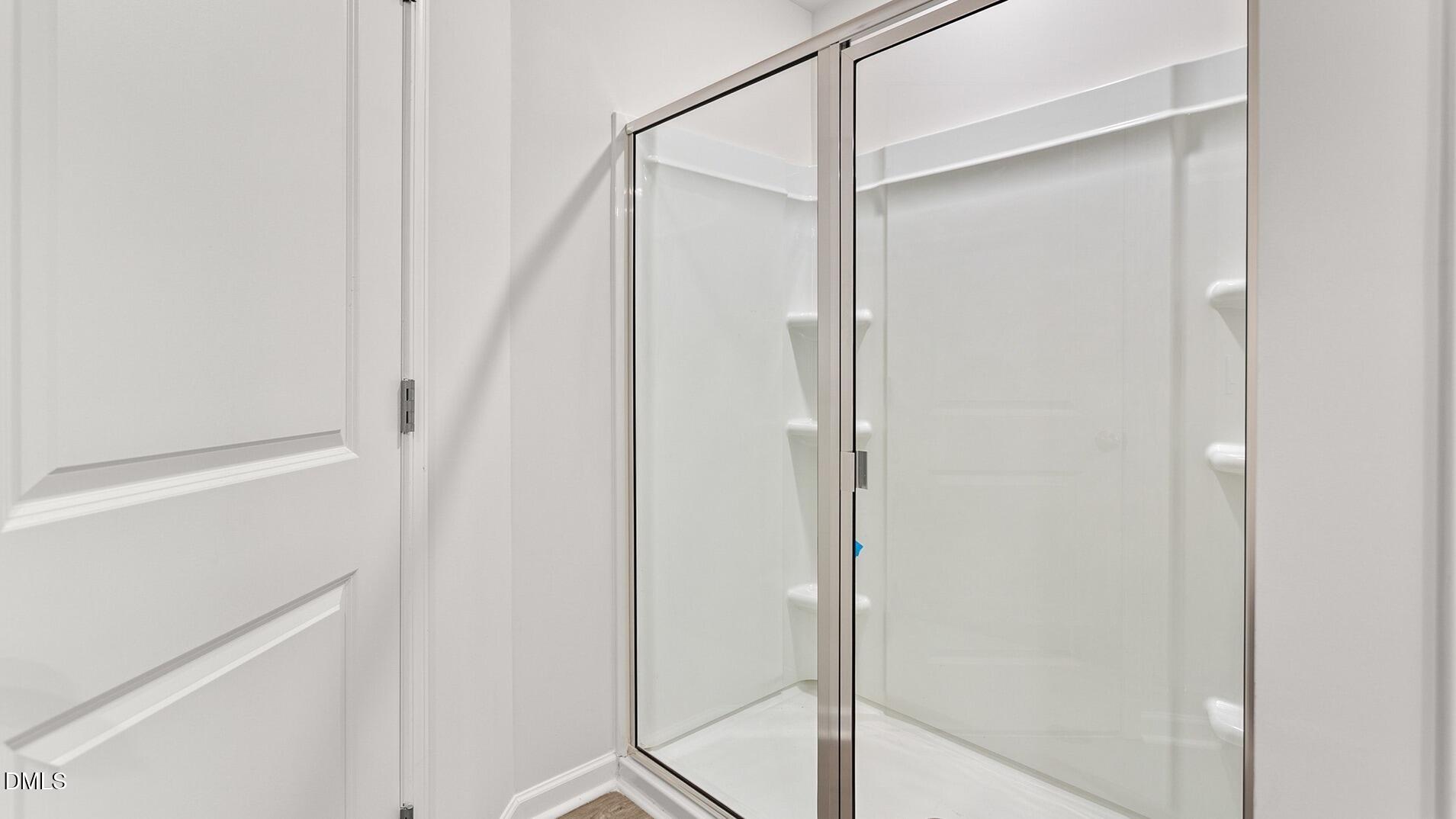 186 Canopy Drive Graham, NC 27253 - Photo 16 of 23 a bathroom with a glass shower door