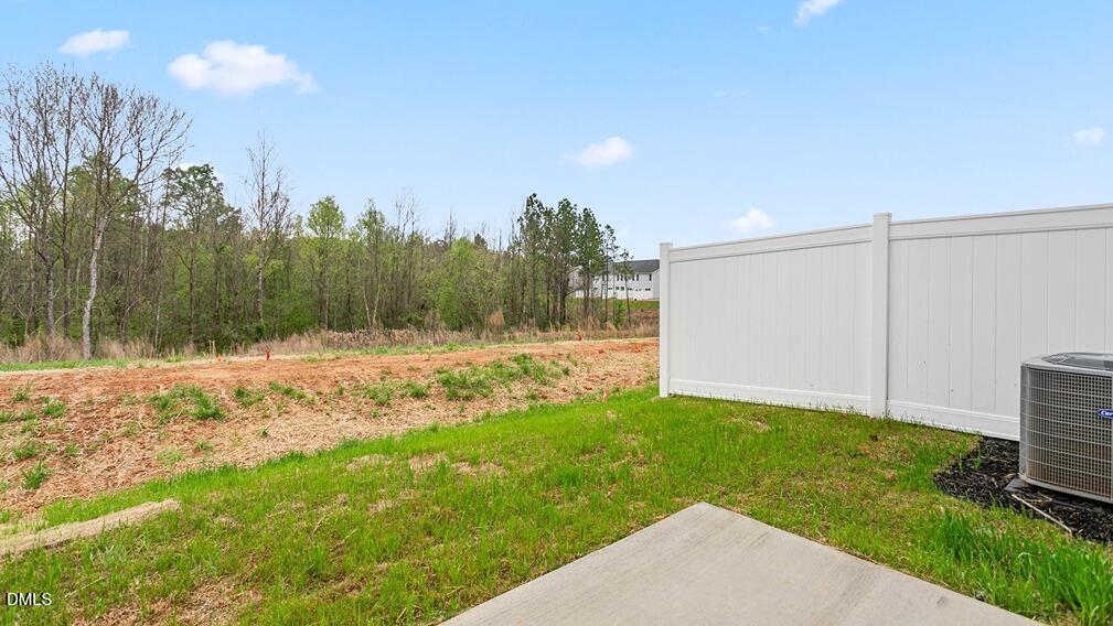 186 Canopy Drive Graham, NC 27253 - Photo 21 of 23 a view of a backyard with potted plants