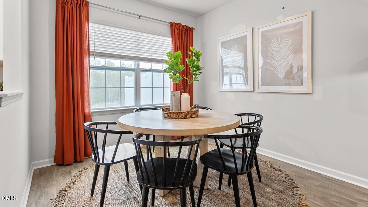 186 Canopy Drive Graham, NC 27253 - Photo 7 of 23 a dining room with furniture and wooden floor