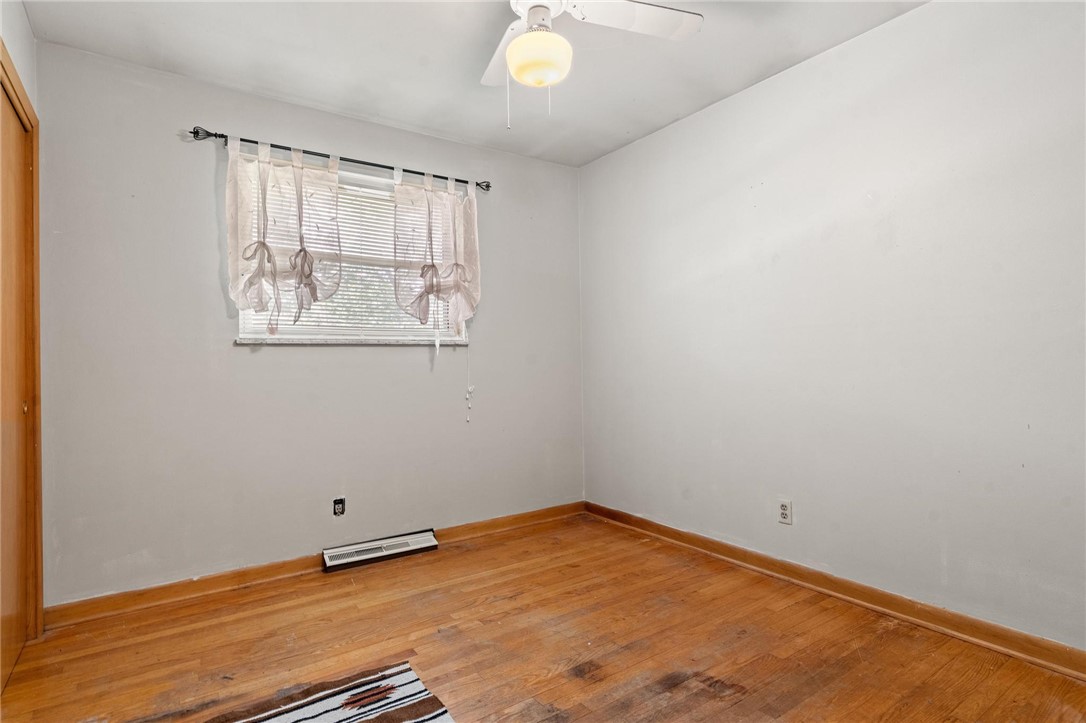 4150 Rose Marie Road Franklin, OH 45005 - Photo 28 of 36 Hardwood floors and a window with blinds define this tranquil, empty space.