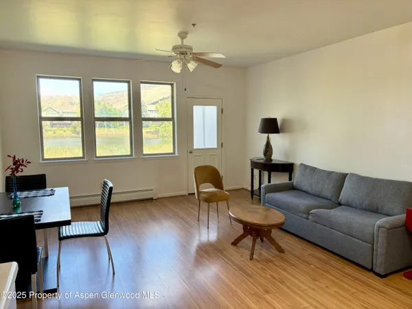 a living room with furniture and a lamp