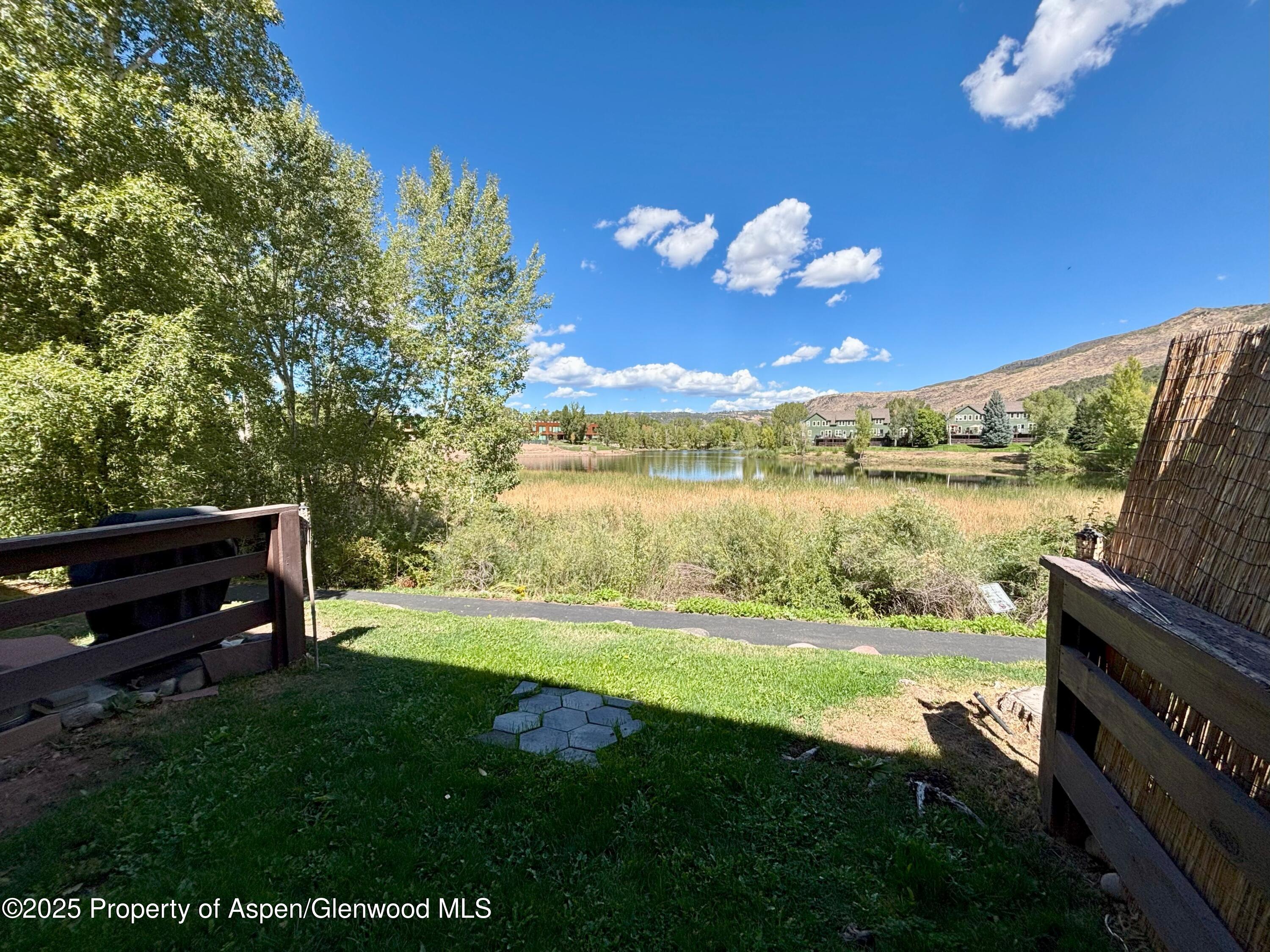 712 Lakeside Drive Basalt, CO 81621 - Photo 14 of 21 a view of a lake with lawn chairs and a table